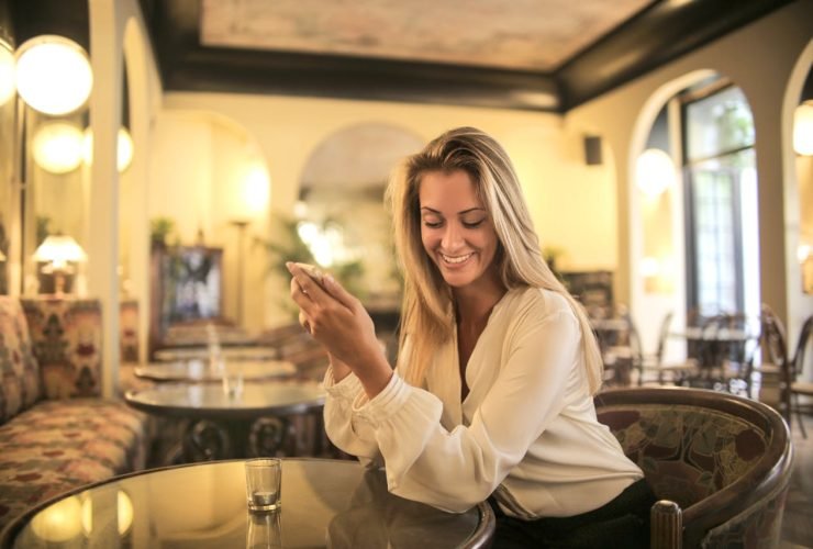 Cheerful female having drink in elegant bar